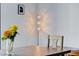 Close-up of dining room table with floral centerpiece and modern lighting fixture at 945 Vegas Valley Dr, Las Vegas, NV 89109