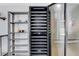 Spacious kitchen featuring a large wine fridge and custom open storage shelves for dishware and copper accents at 945 Vegas Valley Dr, Las Vegas, NV 89109