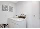 Functional laundry room with washer and dryer, with 'wash & dry' and 'fold & repeat' wall art at 945 Vegas Valley Dr, Las Vegas, NV 89109