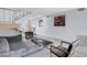 Modern living room featuring sleek furniture, tile floors, modern stairs with metal banister and an artistic painting at 945 Vegas Valley Dr, Las Vegas, NV 89109