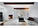 Living room displays a stone fireplace, exposed wood beams, an arched window and modern decor at 945 Vegas Valley Dr, Las Vegas, NV 89109