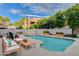 Sparkling pool is surrounded by trees and a brick wall with lounge seating for relaxation at 945 Vegas Valley Dr, Las Vegas, NV 89109