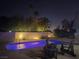 Nighttime shot of the illuminated pool surrounded by trees and lounge seating at 945 Vegas Valley Dr, Las Vegas, NV 89109