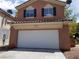 Inviting two-story home featuring a spacious two-car garage and a well-manicured yard at 9937 La Paca Ave, Las Vegas, NV 89117
