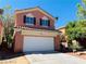Charming two-story home showcasing a tile roof and two-car garage at 9937 La Paca Ave, Las Vegas, NV 89117