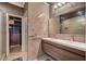 Modern bathroom with double vanity, beautiful tile work, and walk-in closet at 10621 Tinta Ln, Las Vegas, NV 89144