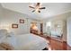 Bright bedroom boasts hardwood floors, mirrored closet doors, and a ceiling fan at 10621 Tinta Ln, Las Vegas, NV 89144