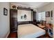 Bedroom featuring a murphy bed, hardwood floors, and a large window at 10621 Tinta Ln, Las Vegas, NV 89144
