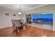 Inviting dining room with wood floors and a glass table, transitioning to an outdoor patio with scenic views at 10621 Tinta Ln, Las Vegas, NV 89144