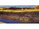 Desert landscape with distant views of city lights at night at 10621 Tinta Ln, Las Vegas, NV 89144