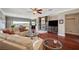 Open-concept living area with hardwood floors, a fireplace, and seamless access to the outdoor living space at 10621 Tinta Ln, Las Vegas, NV 89144