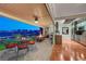 Stylish indoor-outdoor living space with a covered patio, fire pit, and seamless access to the home's interior at 10621 Tinta Ln, Las Vegas, NV 89144