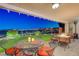 Inviting covered patio with a fire pit, mini golf, and stunning views at 10621 Tinta Ln, Las Vegas, NV 89144