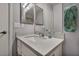 Bathroom features a mirror with a granite countertop sink and a green towel at 1104 Christopher View Ave, North Las Vegas, NV 89032