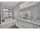 Bright bathroom features a double sink vanity, large tub, and a separate glass shower at 1104 Christopher View Ave, North Las Vegas, NV 89032