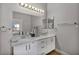 Bright bathroom features a double sink vanity with modern fixtures and ample storage space at 1104 Christopher View Ave, North Las Vegas, NV 89032