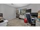 The room features a desk, shelving, plants, and carpeted floors at 1104 Christopher View Ave, North Las Vegas, NV 89032