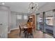 Charming dining area features a modern light fixture, backyard access, and a decorative cabinet at 1104 Christopher View Ave, North Las Vegas, NV 89032