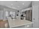 Bright kitchen featuring an island with white cabinets, stainless steel appliances, and wood flooring at 1104 Christopher View Ave, North Las Vegas, NV 89032
