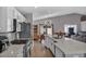 Bright kitchen features an island with white cabinets, stainless steel appliances, and wood flooring at 1104 Christopher View Ave, North Las Vegas, NV 89032