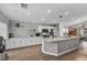 Bright kitchen features an island, stainless steel appliances, white cabinetry, and wood flooring at 1104 Christopher View Ave, North Las Vegas, NV 89032