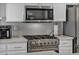 Modern kitchen features stainless steel appliances and white cabinets at 1104 Christopher View Ave, North Las Vegas, NV 89032