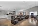 Spacious living room featuring wood flooring, recessed lighting, and open concept to kitchen at 1104 Christopher View Ave, North Las Vegas, NV 89032