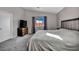 Well-lit bedroom featuring plush carpet and a comfortable, modern bed at 1104 Christopher View Ave, North Las Vegas, NV 89032