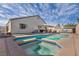 Backyard pool and spa with patio area surrounded by lush landscaping perfect for outdoor entertaining at 1104 Christopher View Ave, North Las Vegas, NV 89032