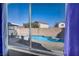Backyard pool view from a window showing the patio area and well-maintained surroundings at 1104 Christopher View Ave, North Las Vegas, NV 89032