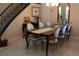 Elegant dining room showcasing staircase, dining table with seating for six at 11268 Corsica Mist Ave, Las Vegas, NV 89135