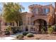 Charming two-story home featuring a stone turret, arched entryway and meticulously landscaped front yard at 11268 Corsica Mist Ave, Las Vegas, NV 89135