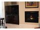 Cozy living room area featuring a modern fireplace and a large flat-screen TV at 11268 Corsica Mist Ave, Las Vegas, NV 89135