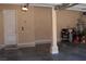Clean two car garage showcasing storage shelves, door to the house, and utility hookups at 11268 Corsica Mist Ave, Las Vegas, NV 89135