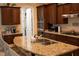 Spacious kitchen featuring granite countertops, stainless steel appliances, and custom cabinetry at 11268 Corsica Mist Ave, Las Vegas, NV 89135