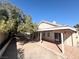 Backyard featuring a covered patio, outdoor kitchen, and a well-manicured yard with mature trees at 1301 Misty View Ct, North Las Vegas, NV 89031