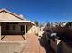 Backyard featuring an outdoor kitchen with built-in BBQ and bar, patio, and block wall at 1301 Misty View Ct, North Las Vegas, NV 89031