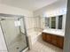 Spacious bathroom featuring a glass shower, soaking tub, and double sink vanity with Hollywood lights at 1301 Misty View Ct, North Las Vegas, NV 89031