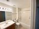 Full bathroom featuring tile floors, a shower and tub combo, and a single sink vanity with a large mirror at 1301 Misty View Ct, North Las Vegas, NV 89031