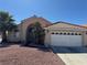 Inviting single-story home featuring stucco siding, a two-car garage, and mature palm trees at 1301 Misty View Ct, North Las Vegas, NV 89031