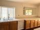 Charming kitchen featuring oak cabinets, tile countertops, a stainless steel faucet, and hardwood flooring at 1301 Misty View Ct, North Las Vegas, NV 89031