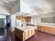 Open kitchen features light wood cabinets, tile countertops, an island, white appliances and hardwood flooring at 1301 Misty View Ct, North Las Vegas, NV 89031