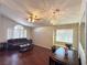 Bright living room featuring wood floors, vaulted ceiling, ceiling fan, and a comfortable seating area at 1301 Misty View Ct, North Las Vegas, NV 89031