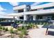 An eye-level exterior shot of the backyard with a pool, lounge seating, patio furniture, and drought-resistant landscaping at 1572 Pleasant Bay Ct, Henderson, NV 89011