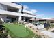 An exterior view of a modern home with a putting green, outdoor living areas and landscaping at 1572 Pleasant Bay Ct, Henderson, NV 89011