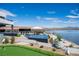 Resort style backyard with putting green, pool, swim up bar, and lake views at 1572 Pleasant Bay Ct, Henderson, NV 89011