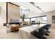 Open concept living and dining area with modern decor and expansive windows offering water views at 1572 Pleasant Bay Ct, Henderson, NV 89011