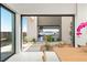 A bright living space with floor to ceiling windows overlooking an outdoor space, lake and mountains at 1572 Pleasant Bay Ct, Henderson, NV 89011