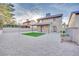 The low-maintenance backyard features gravel, turf, and a covered patio area at 163 Spinnaker Dr, Henderson, NV 89015