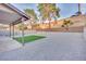 Large backyard featuring a gravel yard, low-maintenance turf, and a block wall perimeter at 163 Spinnaker Dr, Henderson, NV 89015
